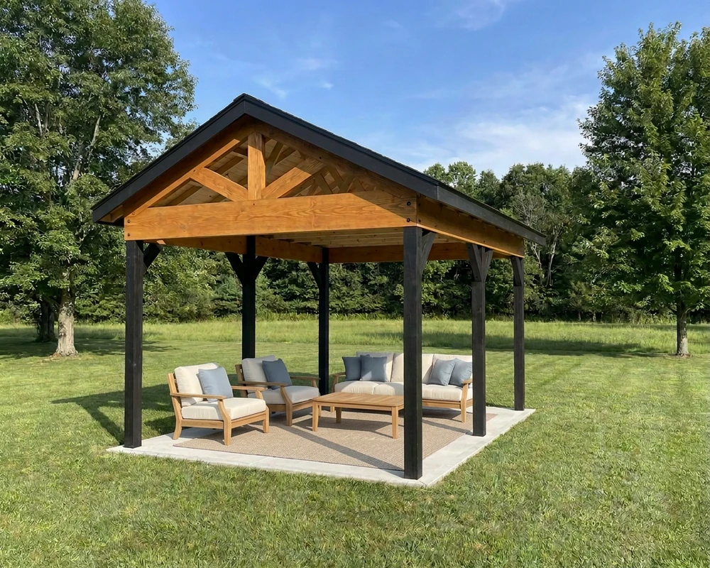 12×16 backyard pavilion with black posts, a stained timber gable and a lounge set on a concrete patio